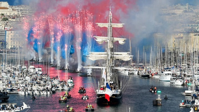 Olympic flame sails into Marseille port, marking milestone on path to Paris Games
